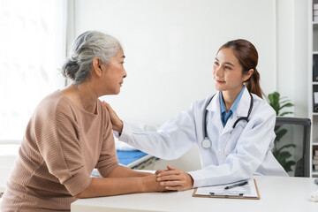 Fototapeta premium Doctor offering compassionate care and support to an elderly woman in a hospital or clinic setting, focusing on empathy