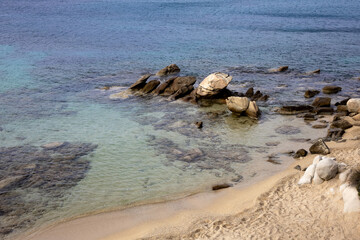 sea background with clear blue water, sandy and rocky shore. aegean seascape with no people. calm sea water surface. sandy