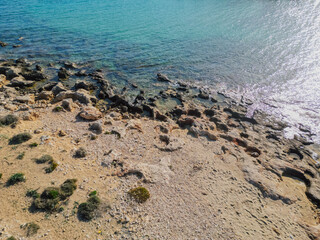 Rocky coastline on Crete island with crystal clear azure sea water under the summer sun