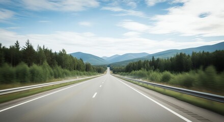Fototapeta premium Straight road through forest with mountains in distance