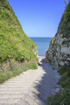 Old concrete access road in the Valleuse d'Etigue, hike from Yport to Etretat along the chalk cliff coast, Seine-Maritime department, France