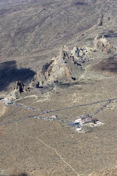 Panorama during the ascent to Alto de Guajara, 2715m, to the bizarrely shaped rock formations of volcanic rock, Roques de Garc&iacute;a, the visitor centre and the Hotel Parador, at sunrise, Teide National Park, Parque Nacional del Teide, Tenerife, Canary Islands, Spain