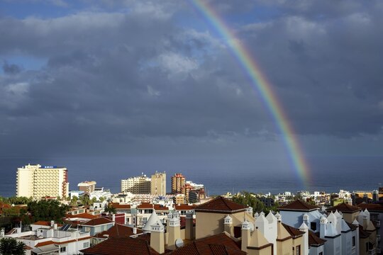 Rainbow over Puerto de la Cruz and thunderclouds over the Atlantic Ocean, Tenerife, Canary Islands, Spain
