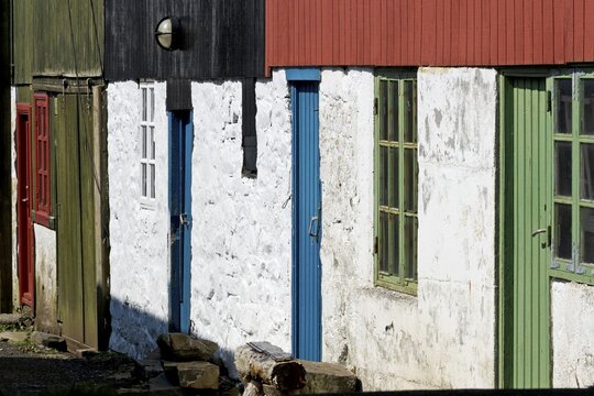 Detail of traditional whitewashed houses with colour-painted timber cladding, Mykines Island, Faroe Islands, Denmark