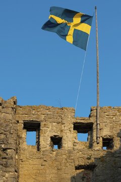 Old city wall with flag or banner of Sweden, former Hanseatic city of Visby, UNESCO World Heritage Site, Gotland Island, Sweden