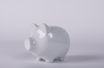 A white piggy bank on a plain white background representing savings, financial growth, and investments. Perfect for illustrating concepts of wea