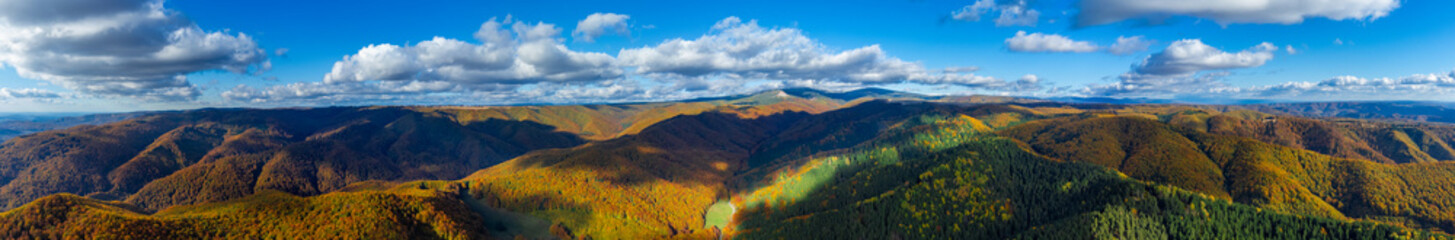 Panoramic aerial view with colorful mountains and forests in autumn. Carpathian mountains seen from above in autumn