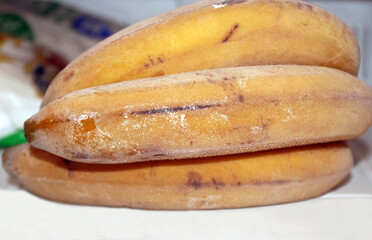 Whole ripe frozen bananas inside freezer