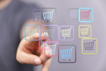 Person's hand touching online shopping cart icons. Concept of e-commerce, shopping online, digital marketing and retail. Great for business and