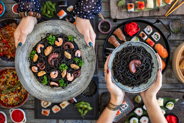 Black spaghetti with cuttlefish ink. Black seafood pasta with octopus, shrimp and mussels. 