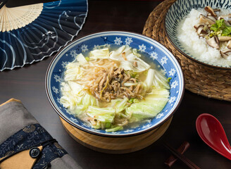 Asian Pickled mustard greens and shredded pork noodles soup. Featuring fresh cabbage and flavorful toppings, it's a comforting and healthy meal to enjoy any time