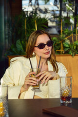 Young woman in a cafe drinking ice coffee