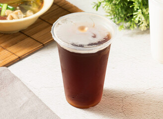 Iced black tea refreshment for a hot day, cool down with this delicious drink, a sweet escape in a cup, served in takeaway cup, perfect for summer