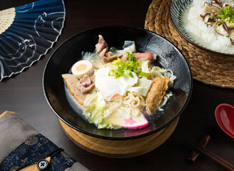 Assorted Japanese Champon noodle soup with flavorful ingredients like pork, egg and kamaboko in a vibrant setting, a culinary delight to savor