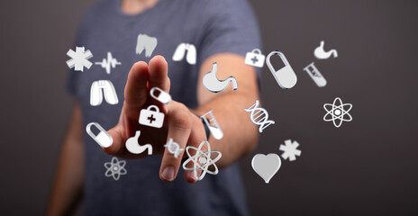 Person interacts with floating medical icons.  Perfect for telehealth, medicine, technology concepts.