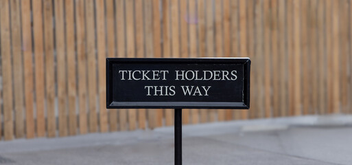 Ticket Holders This Way sign - white trext on black background