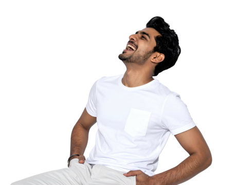 Smiling young man in white tee & pants, looking up, hands in pockets