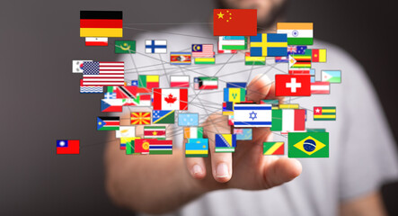 An image showing a hand connecting to a network of international flags, representing global connections, communication, and unity. Suitable for