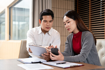 Two Asian businessman talk, consult, discuss working with new startup project idea presentation...