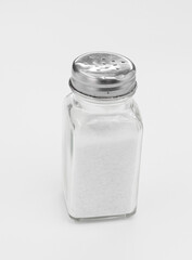 Glass Salt Shaker With Metal Top in Minimalist White Studio Shot for Kitchen and Cooking