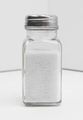 Glass Salt Shaker With Metal Top in Minimalist White Studio Shot for Kitchen and Cooking