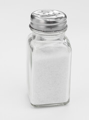 Glass Salt Shaker With Metal Top in Minimalist White Studio Shot for Kitchen and Cooking