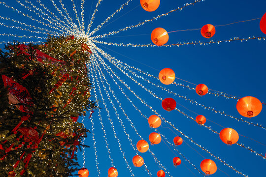 A Chinese New Year Christmas tree decorated with red lanterns, a festive winter festival on the streets of the city
