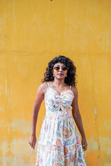 Fototapeta premium She is wearing sunglasses and has her arms crossed