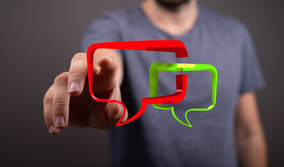 Concept of online communication demonstrated with a man touching speech bubbles for message...