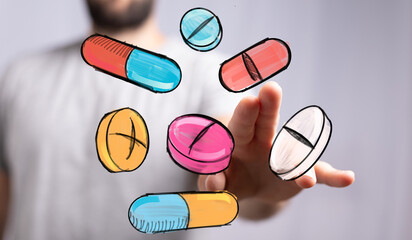 Image of hand interacting with floating colorful pills and capsules, perfect for healthcare, medicine, or pharmacy concepts.