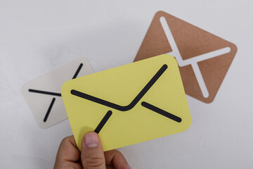 A close-up shot of colorful mail cards in hands on a white surface, conveying concepts of...