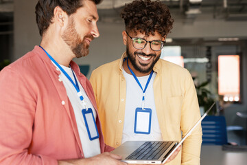 Diverse business team collaborating on laptop in office