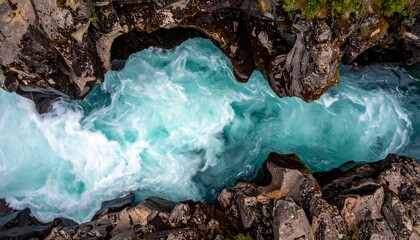 Vibrant Turquoise Rapids: Aerial Long Exposure of Rushing River in Dark Rocky Gorge