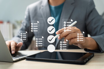 Task management and digital checklist concept. Businessman using stylus on tablet with virtual checklist icon for workflow planning, productivity, approval process, and organized project tracking.