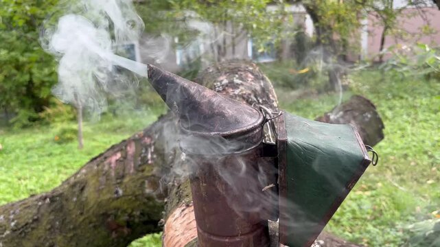Smoke blowing from traditional bee tool