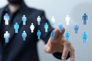 Human hand pointing at digital human symbols. Concept for leadership, teamwork, business connection...