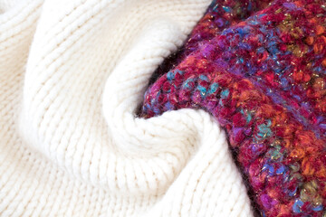 Knitted woolen sweaters. A bunch of knitted winter, autumn clothes, sweaters, knitwear, space for the text.