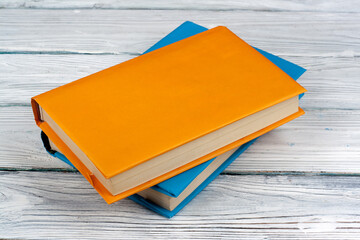 Multi-colored books on a white wooden table. Copy space for text.