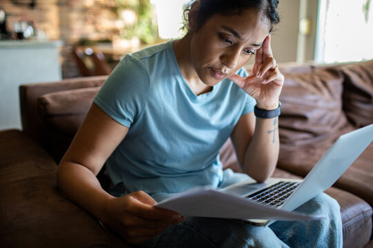 Woman working on laptop at home