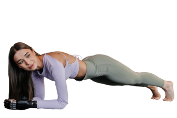 Beautiful brunette caucasian girl in sportswear with bionic hand makes plank exercises on transparent background. Fit Italian female with limb prosthesis at workout.