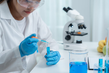 Fototapeta premium Scientist check chemical food residues in laboratory. Control experts inspect quality of fruits, vegetables. lab, hazards, ROHs, find prohibited substances, contaminate, Microscope, Microbiologist