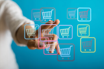 Hand interacting with digital shopping carts, illustrating e-commerce, online shopping, and digital...