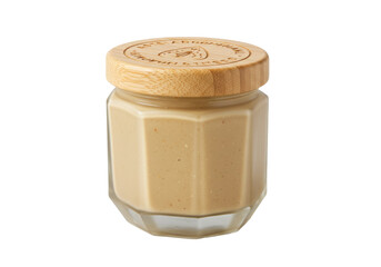 Jar of tahini isolated, creamy sesame seed paste in glass jar with wooden lid, healthy vegan food ingredient for cooking and baking
