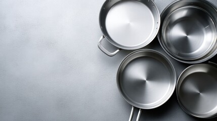 Top view of assorted metallic cooking pans, ideal for recipe photography or cooking tutorial mockups.