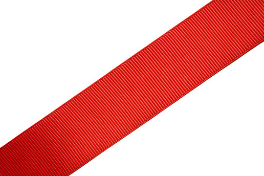A bright red textured ribbon piece with a distinct pattern is presented diagonally, completely isolated on a clean transparent background.