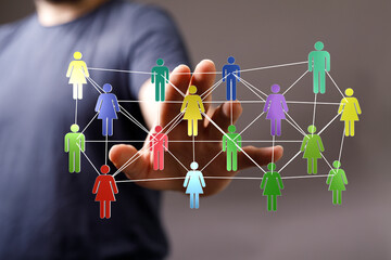 Hand reaching towards a network of diverse people connected by lines, representing concepts like...