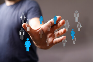 Concept of connection, community and relationship with human icons on a person's hand. Represents networking, diversity, teamwork, and social in