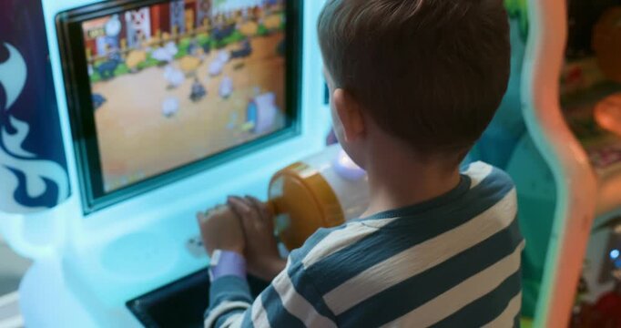 Child Enjoying Arcade Game at Entertainment Center