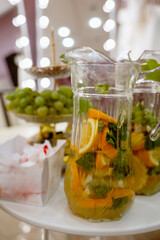 A pitcher of refreshing fruity orange tea with ice and mint.