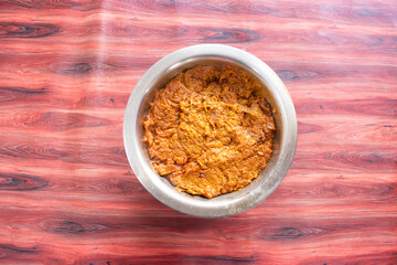 A mouthwatering bowl of golden-brown food sits on a vibrant red wood surface. Ideal for restaurant menus, food blogs, recipe books, and culinary presentations. This image evokes feelings of warmth